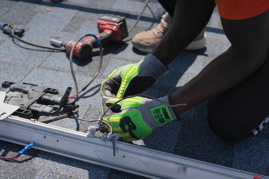 Professional solar panel installers working on a residential roof